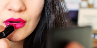 Woman Applying Lipstick